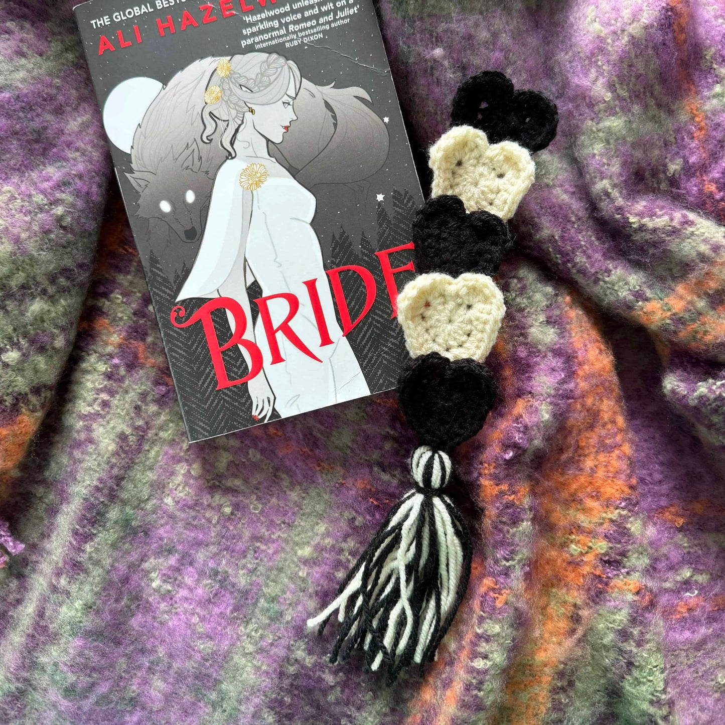Black and white heart bookmark on a textured fabric background