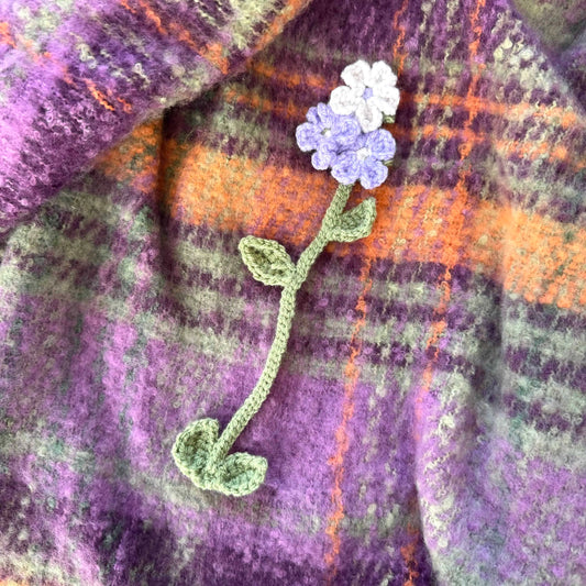 Floral bookmark on a plaid fabric background