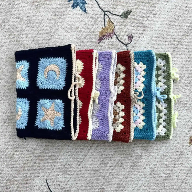 Colourful crocheted book covers with geometric patterns.