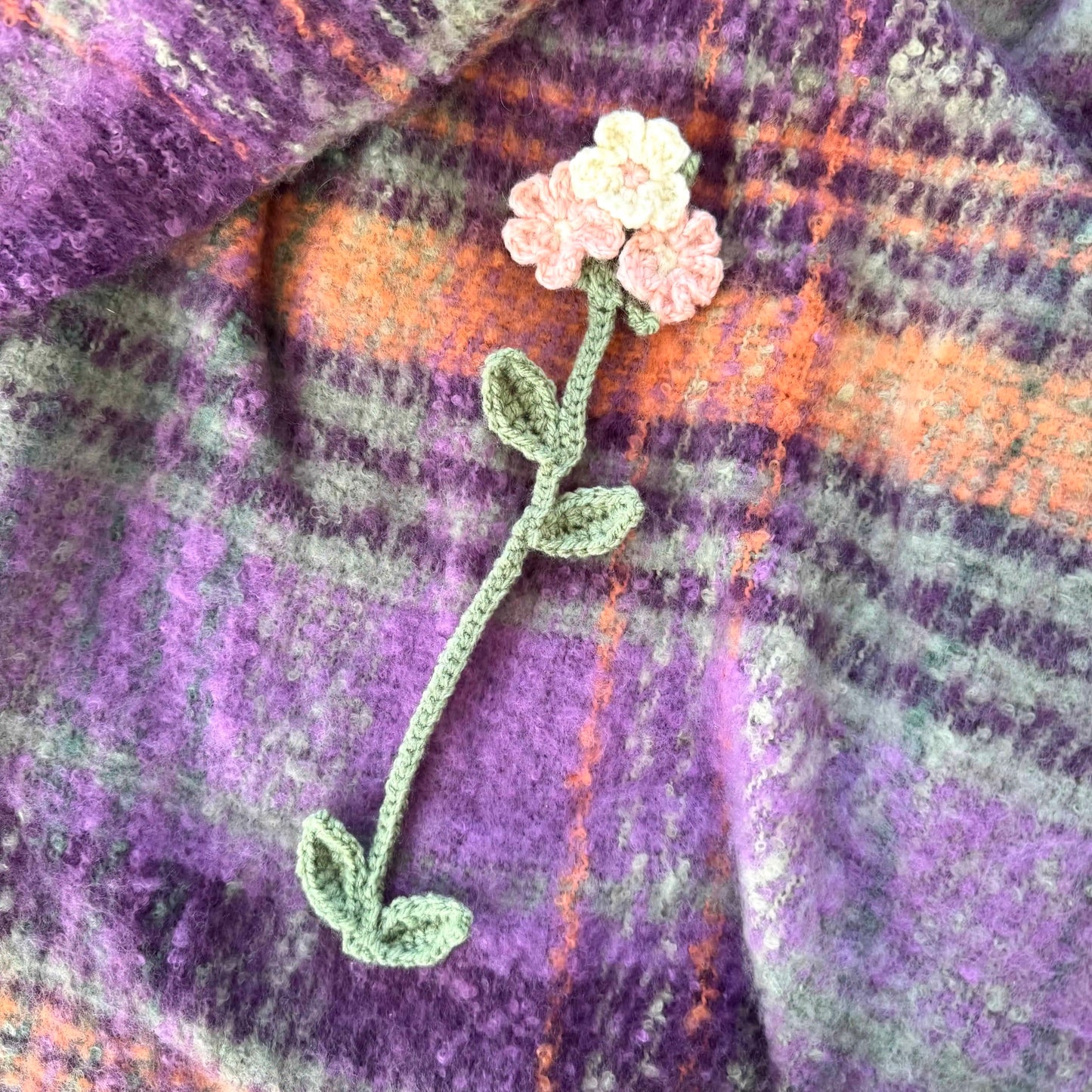 Floral bookmark on a plaid fabric background