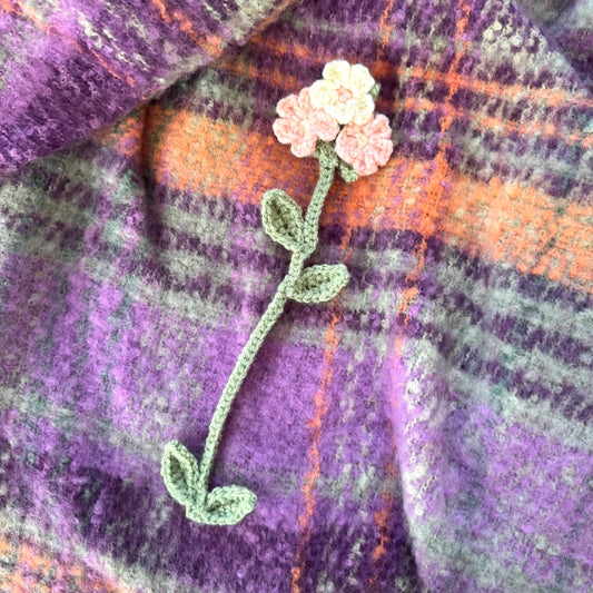 Floral bookmark on a plaid fabric background