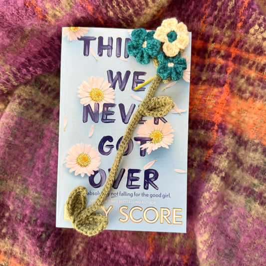 Crochet flower bookmark on a textured fabric background
