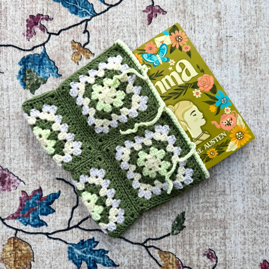 Crocheted green and white book cover with a book titled 'Emma' by Jane Austen.