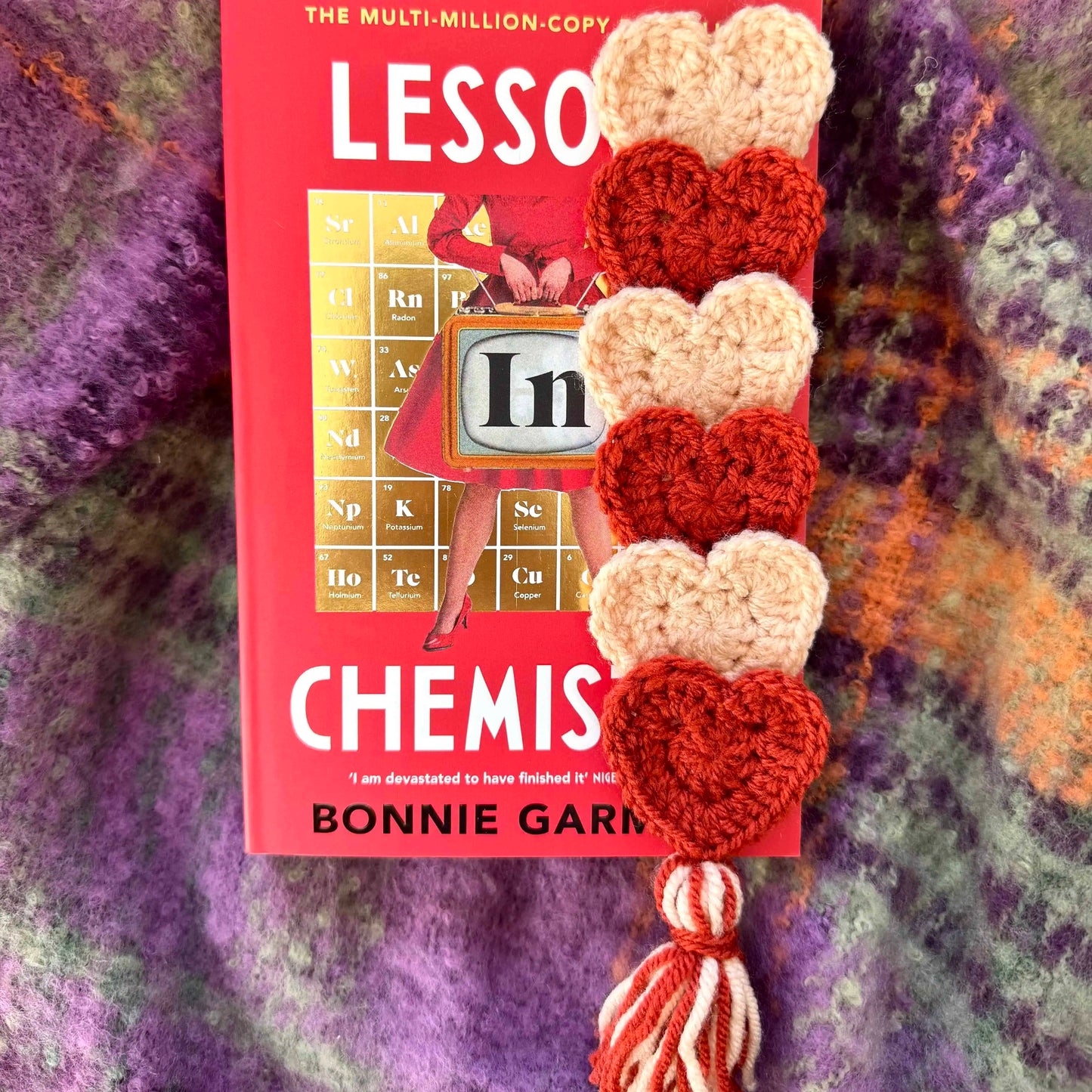 Crochet heart bookmark on a textured background
