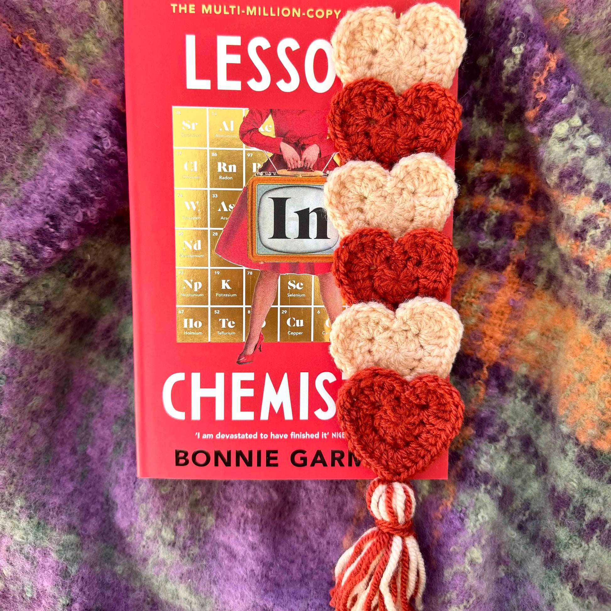 Crochet heart bookmark on a textured background