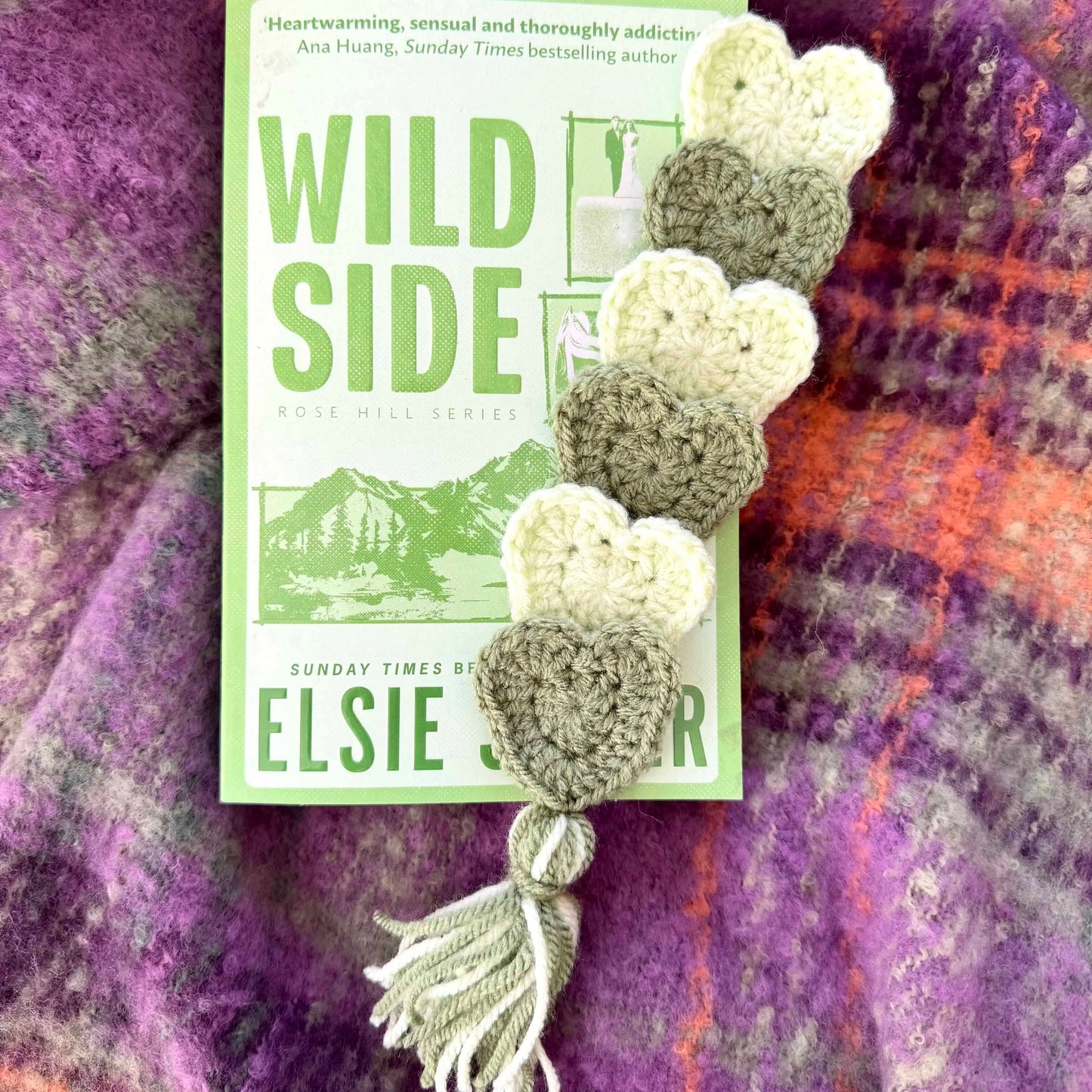 Crocheted heart-shaped bookmarks on a book titled 'Wild Side' by Elsie R.